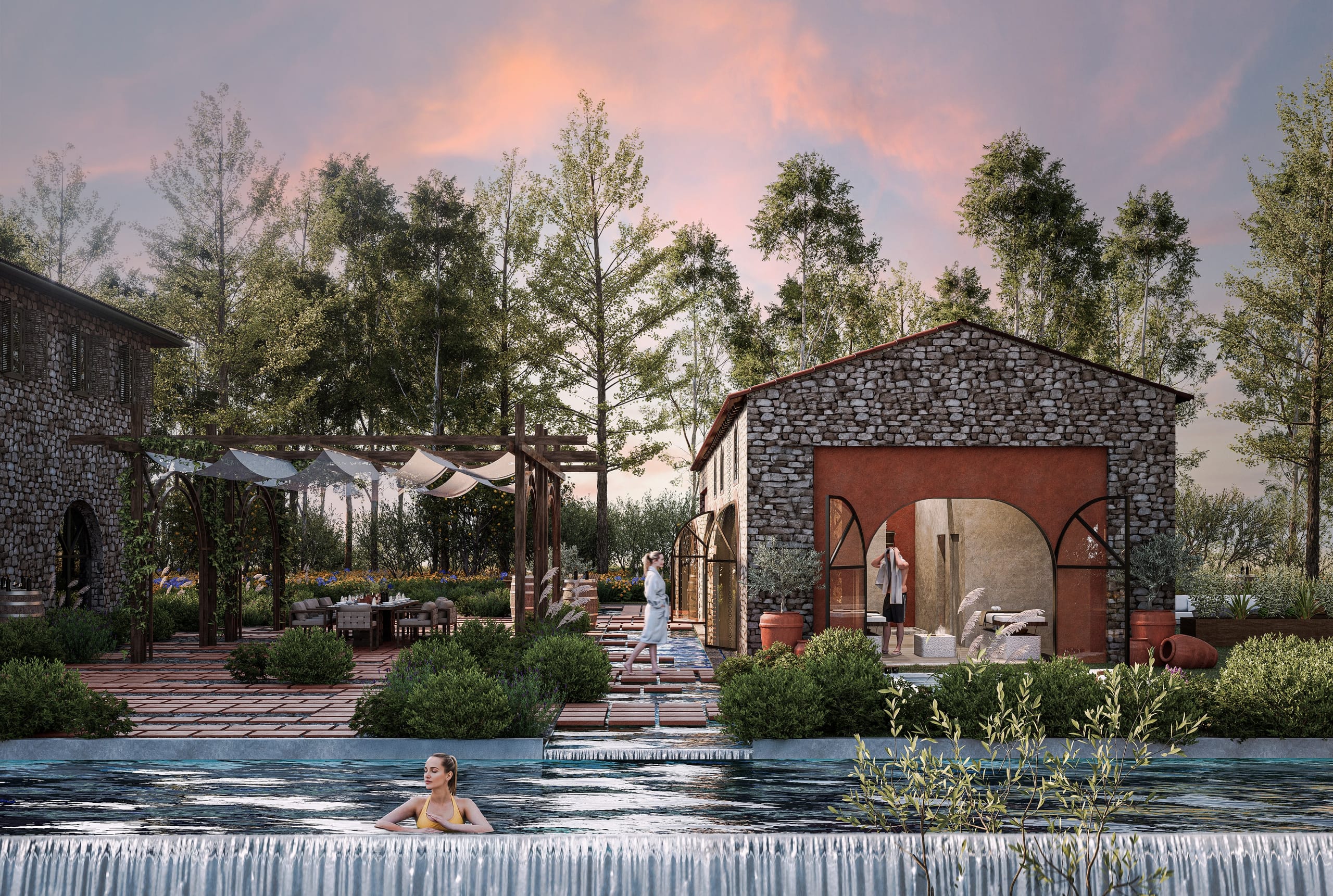A woman in the infinity pool below the courtyard, with terracotta stepping stones over water leading past the pergola and dining table to the stone spa building.