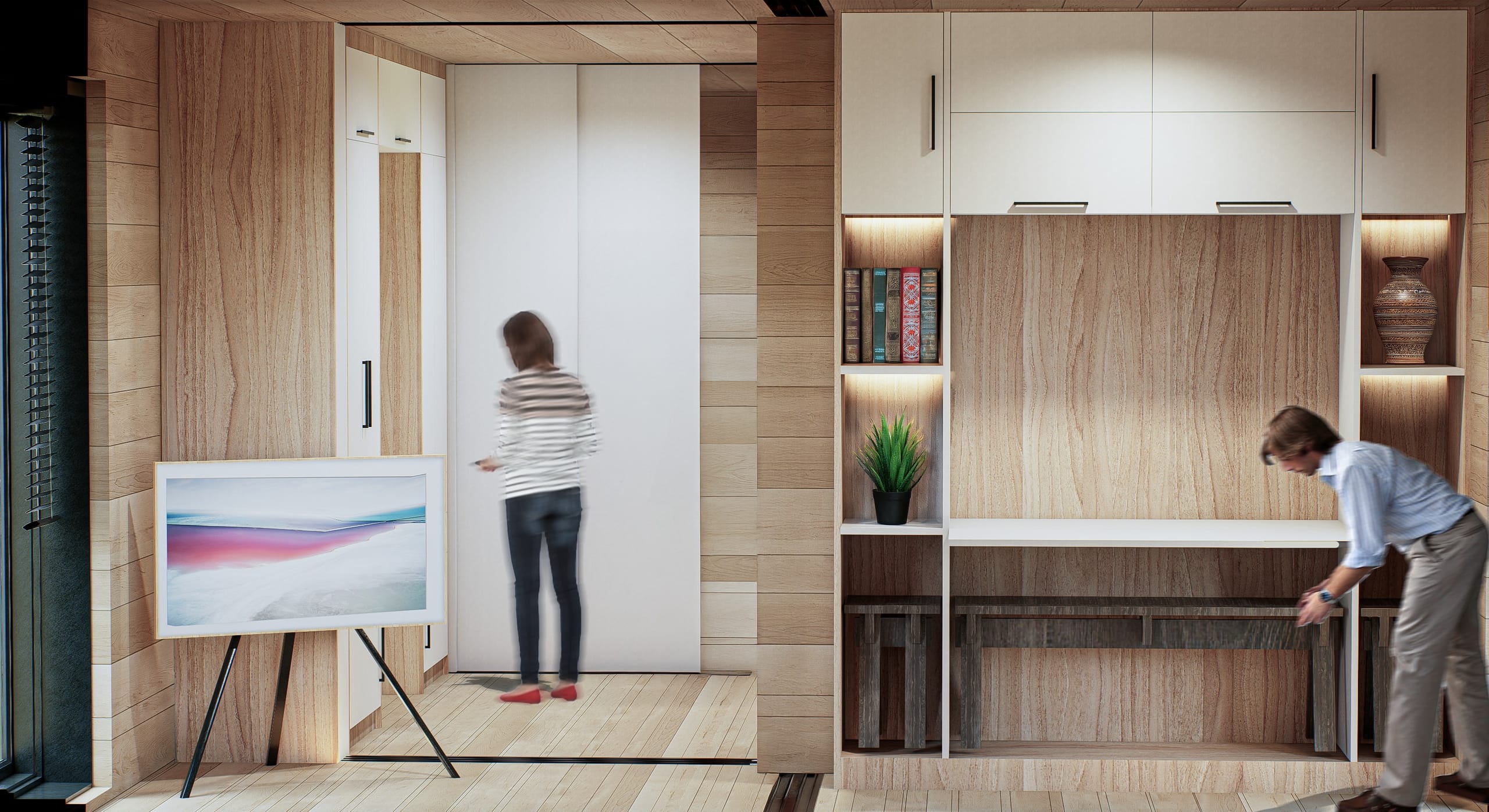 Timber-lined living space with a framed screen on an easel, a woman by a sliding white wardrobe door, and a man pulling a fold-out bench from a built-in shelving and desk unit.