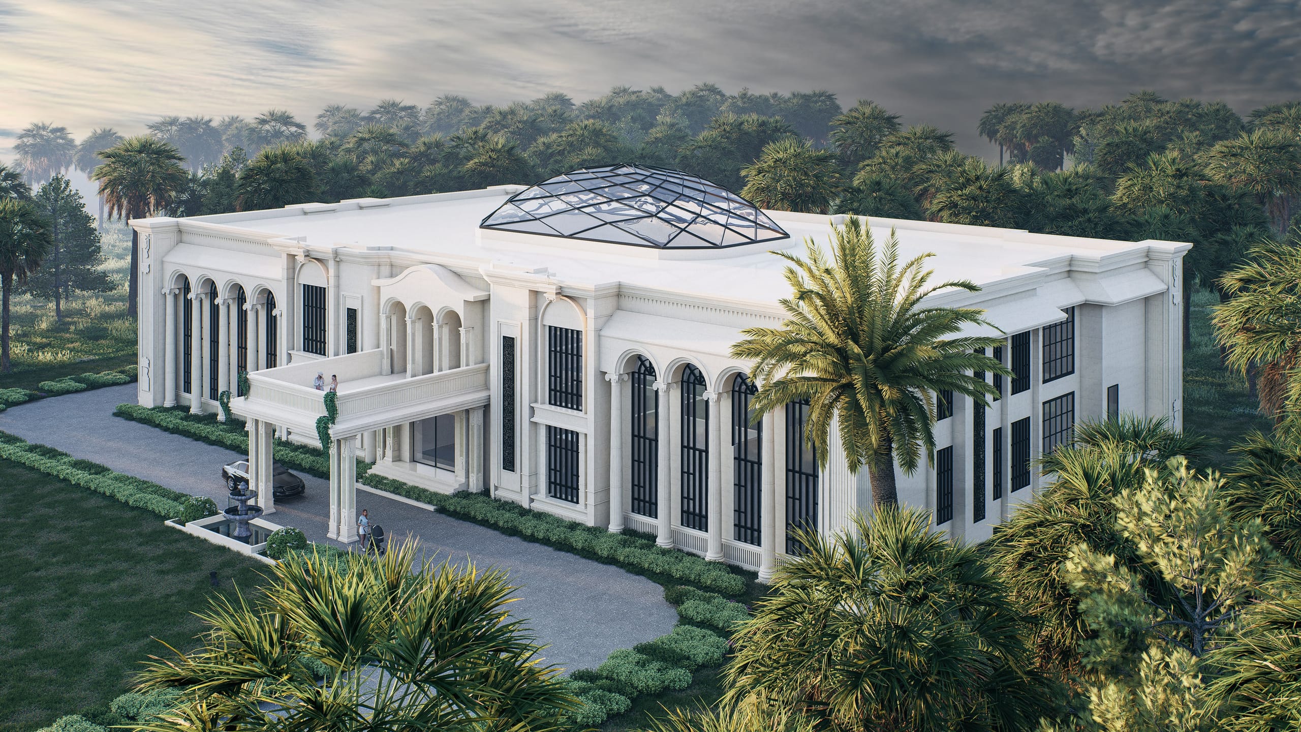 Elevated view of the villa at dusk with the glass dome on the roof, palms in the foreground and a couple on the entrance balcony.