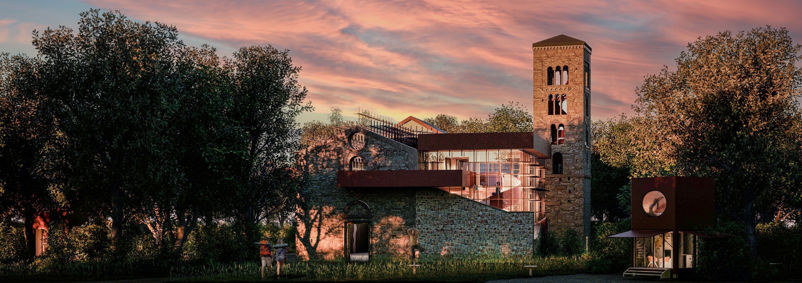 The stone abbey of Santa Maria del Piano at sunset among trees, with a wooden grid over its open roof, a glazed volume under a rusted steel canopy beside the bell tower, a small retreat pod on the right and hikers walking towards the ruin