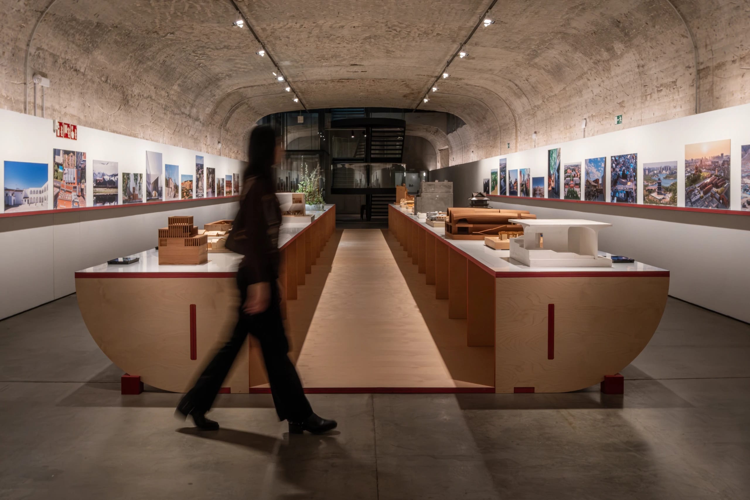 A woman walking through an architectural exhibition in Madrid