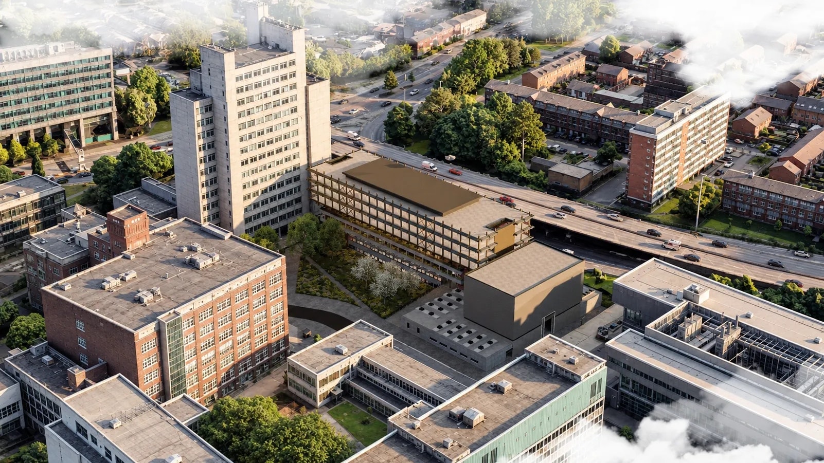 Daytime aerial view of the Ferranti Building on Manchester's North Campus beside the Mancunian Way, with its new timber-framed performance hall, planted courtyard and surrounding university buildings