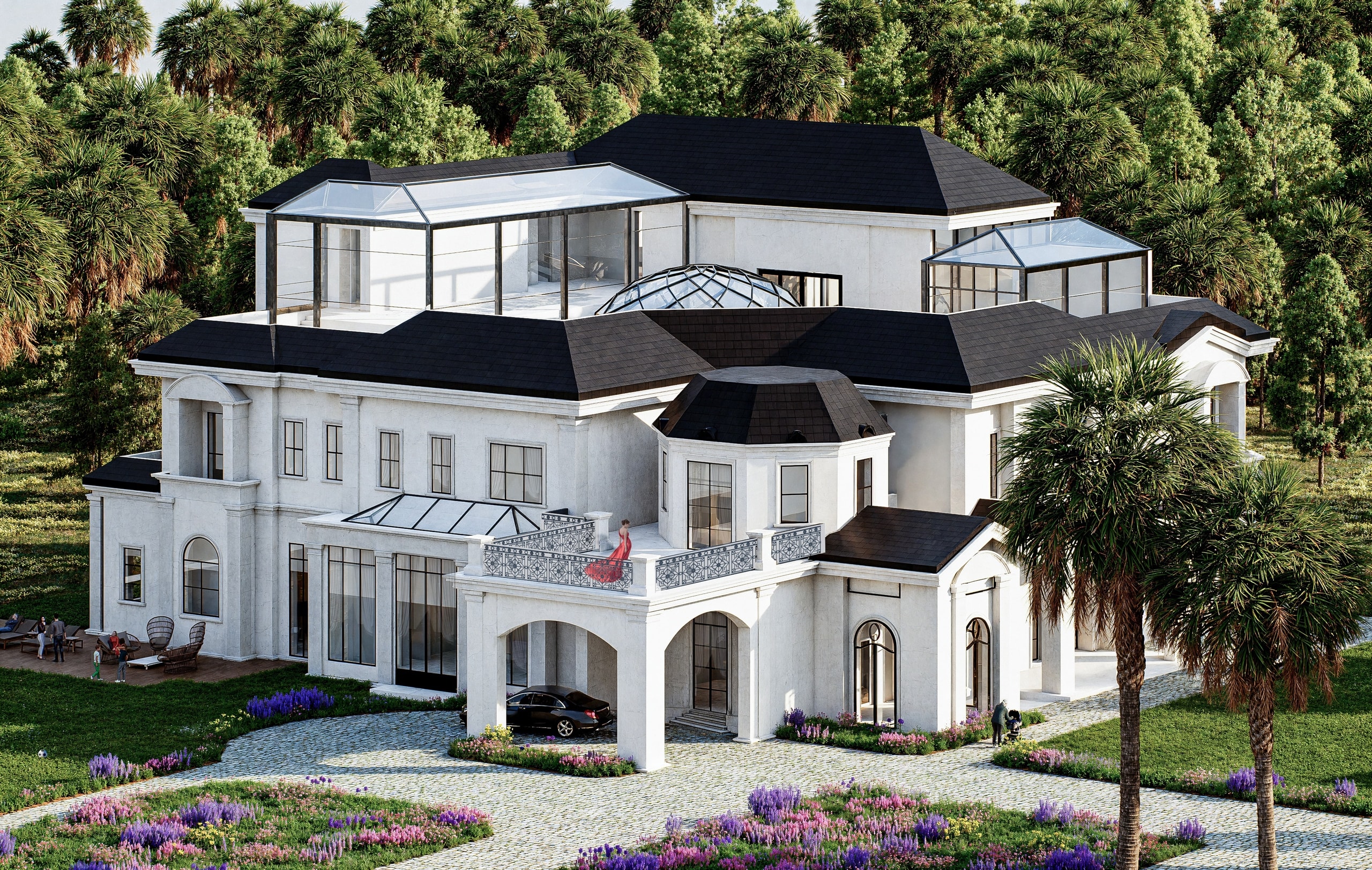 Elevated view of a white villa with dark slate roofs, glass rooftop pavilions and a faceted glass dome over the centre, an entrance porch with a balcony, a cobbled drive and flowering beds among palm trees