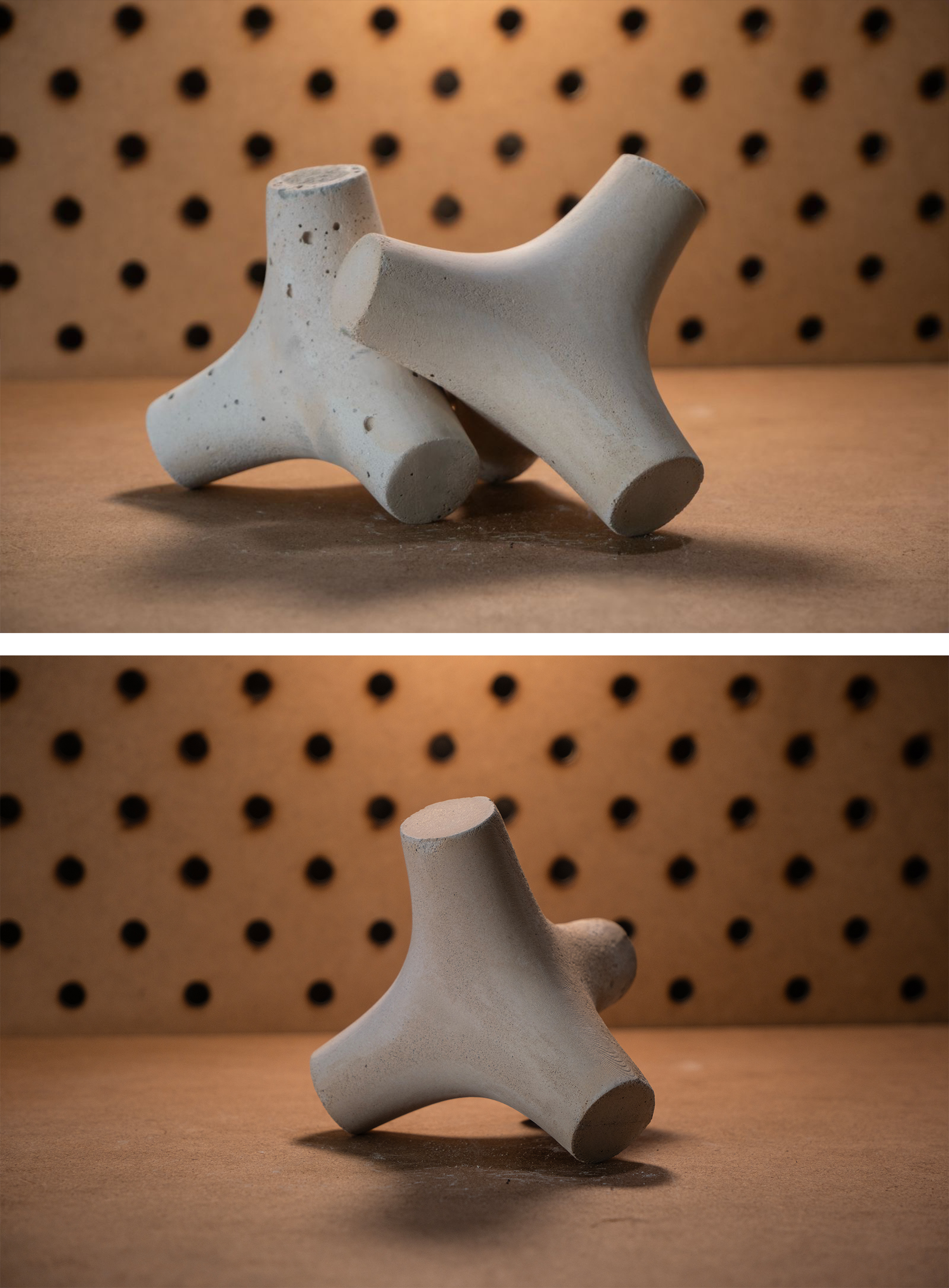 Two photographs of cast concrete tetrapod models on a workshop table in front of a perforated board, one showing two interlocking units and one a single unit.